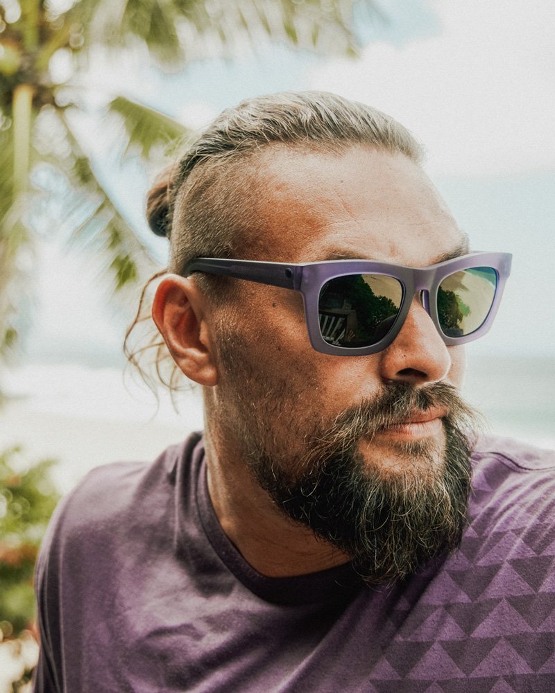 Jason Momoa wearing the Unity Purple Nakoa Tee and Unity Purple Crasher sunglasses